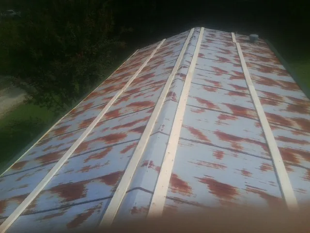 Rusted metal roof panels with new wood purlins before replacement — Storm Damage Roof Repair in New Berlinville by Roofing Brothers