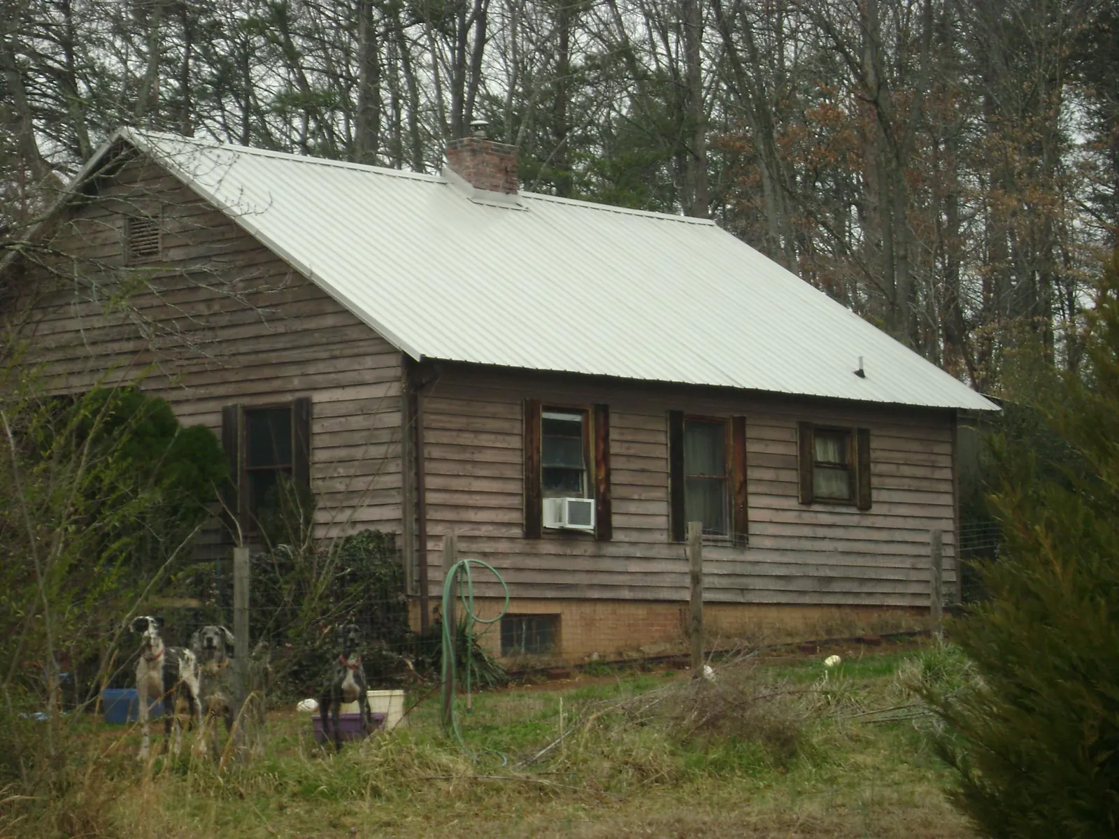 White metal roof on an old wood sided farmhouse, from a Asphalt Shingle Roof Repair job in New Berlinville